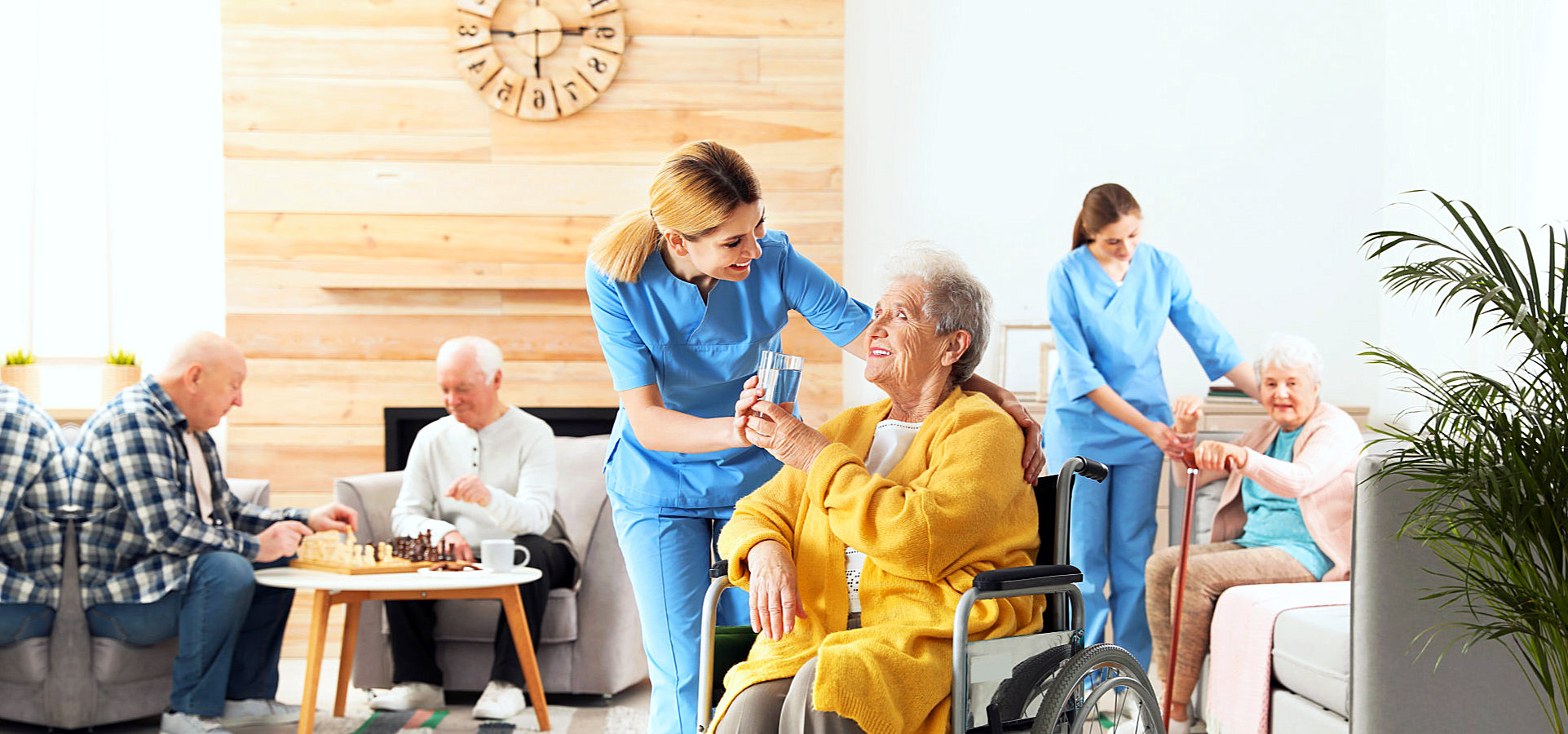 group of seniors in a room with caregivers
